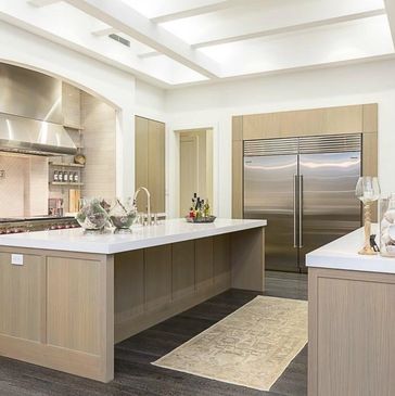 Modern kitchen with a large island and stainless steel appliances.