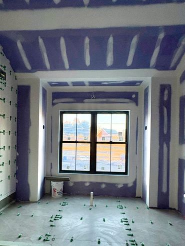 Primary bath tile and sheetrocked with one coat of tape and spackle