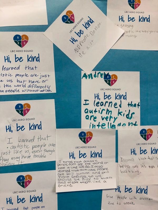 Notes from kids about autism and kindness on a bulletin board.