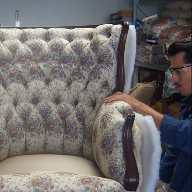 Owner restoring antique chair.