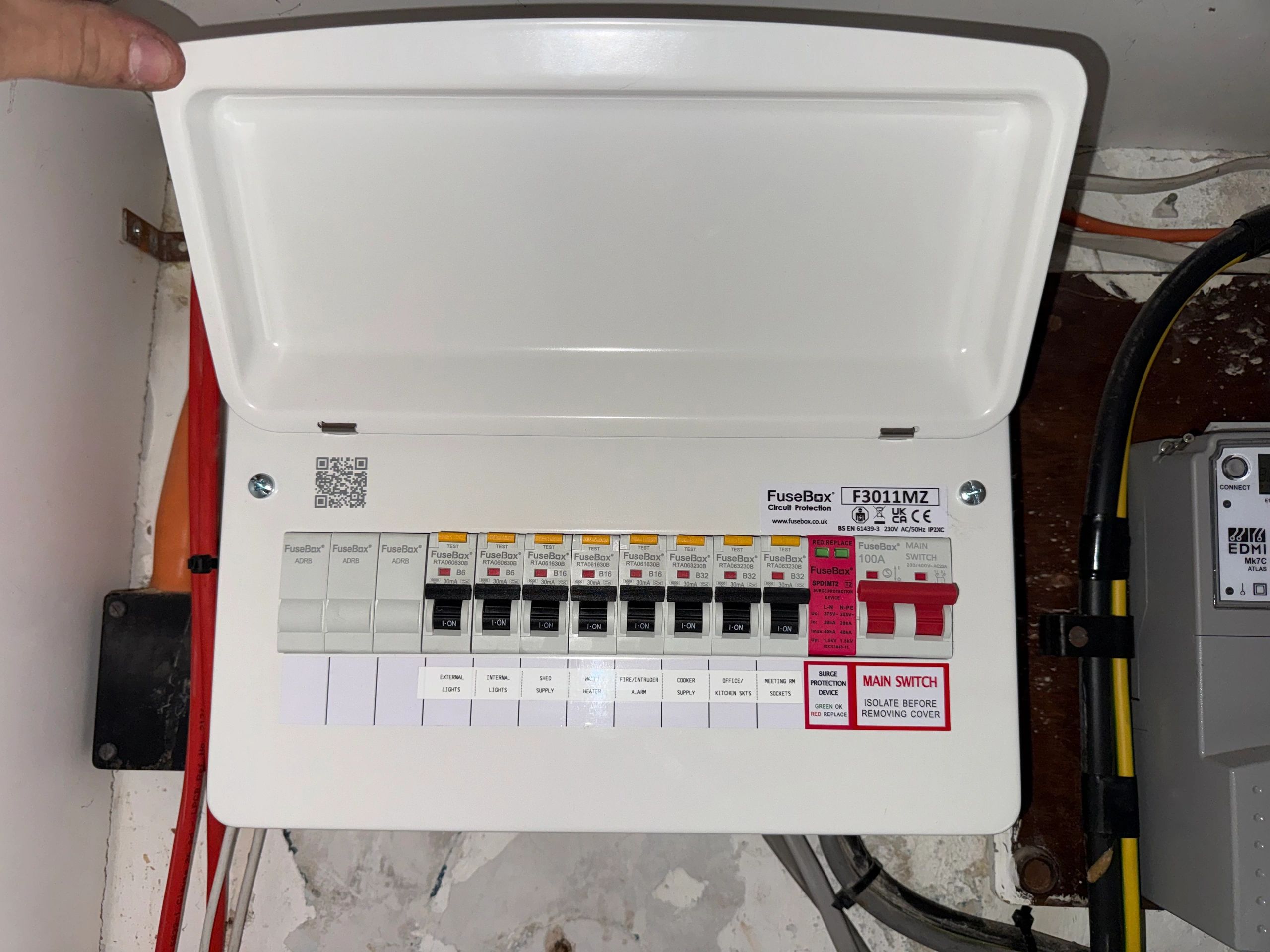 Fuse box panel with circuit breakers and labels.