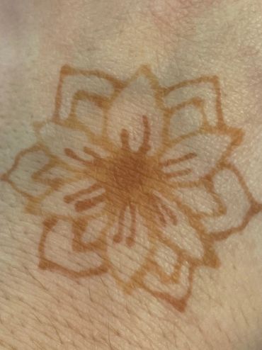 Henna ink flower on skin