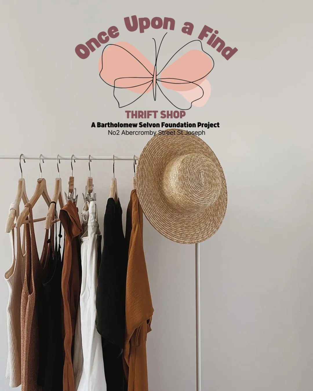 Clothes and a hat hanging with a thrift shop logo.