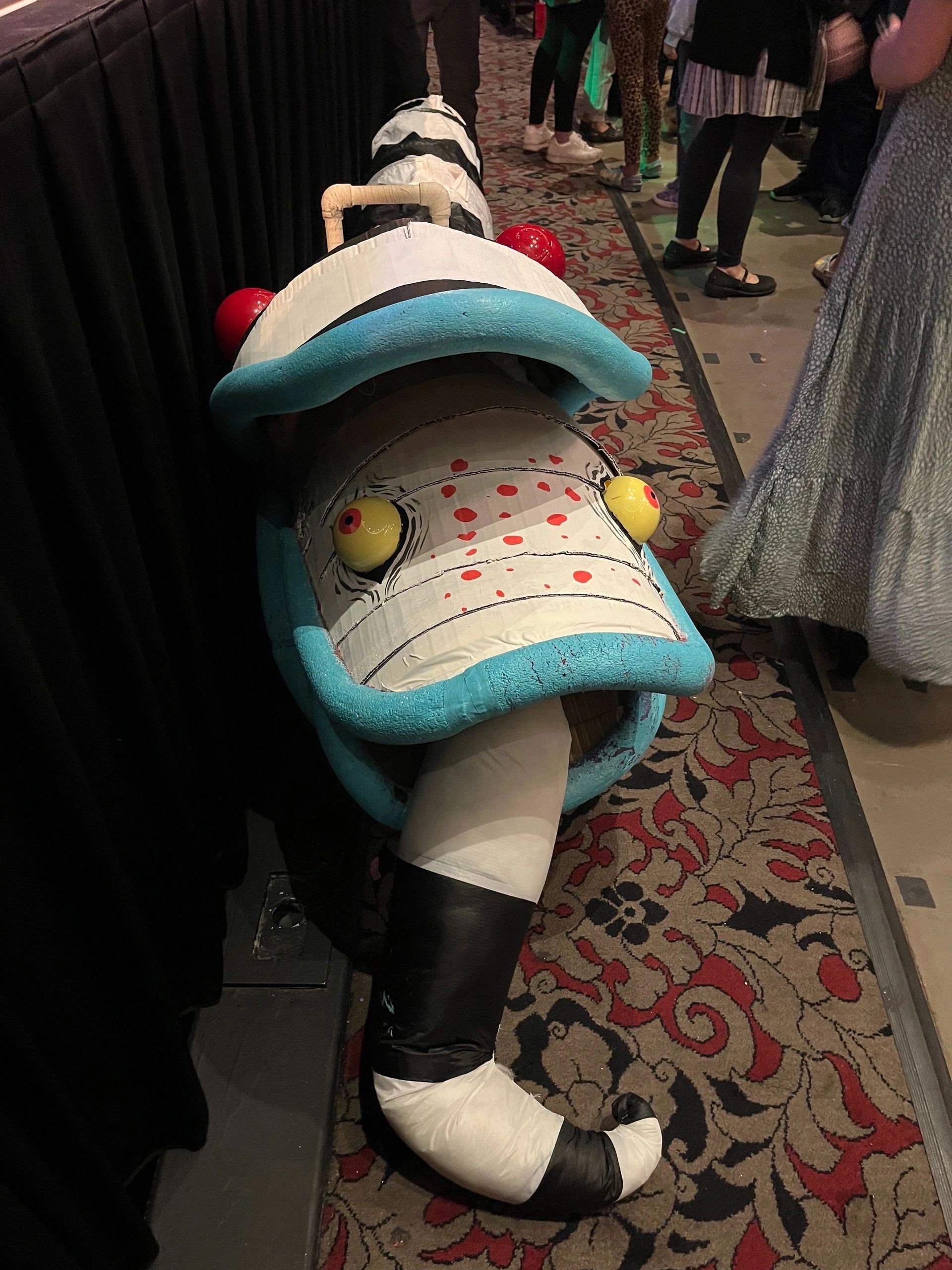 Large colorful sea creature costume at event.
