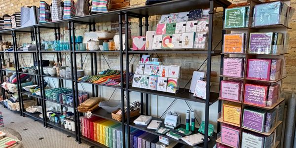 Colorful store shelves displaying stationery, gifts, and home goods.