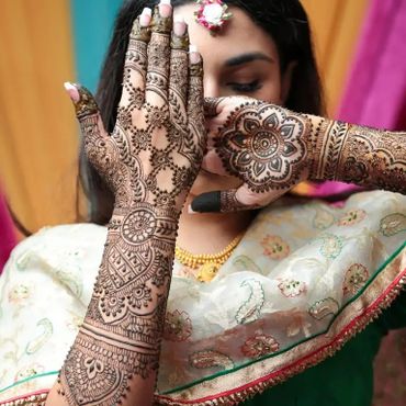 Intricate henna designs on a woman's hands at a traditional event. makeup artists in tirupati, Pavizmakeover