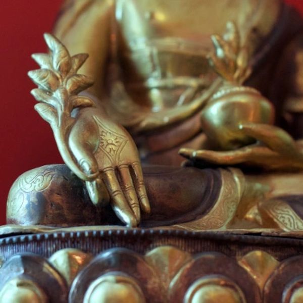 A close-up of a carved wooden Buddha statue.