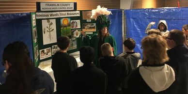 FCNWCB Education Coordinator Betsy Crysel in her Scotch thistle costume speaks to a school group.
