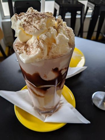 Stack of pancakes crowned with vanilla ice cream