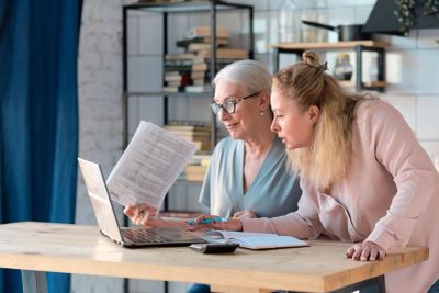 Two women working together at a laptop.