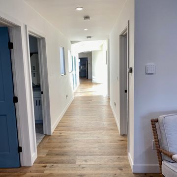 Sand-colored wide plank flooring, ADA-compliant hallways and doorways