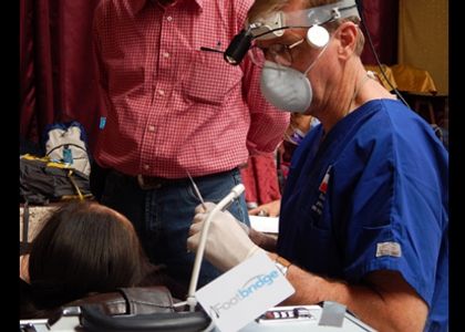 A dentist treating a patient on a short-term mission trip