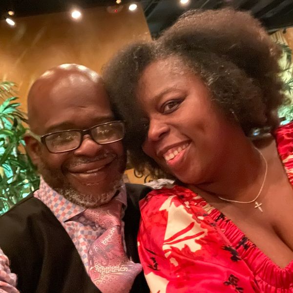 Pastor Kelvin and Charlett Cox smiling together—a portrait of love, faith, and partnership.