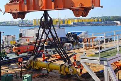 Offshore installation equipment being lifted and prepared for deployment.