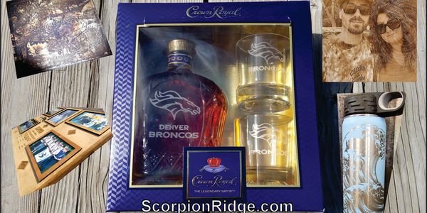 Custom engraved Denver Broncos whiskey set and personalized wooden photo frame on a rustic wooden table.