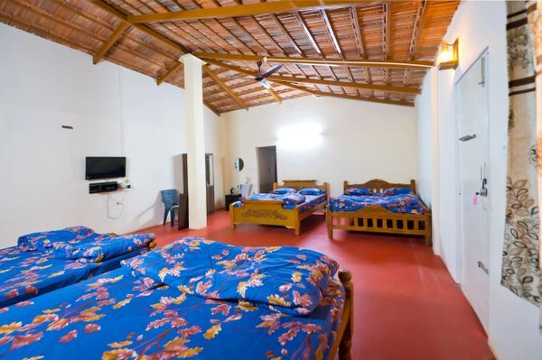 Cozy and spacious interior of the family cottage at Namooru Ecostay, designed for comfort and relaxation.