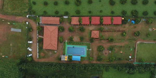 Aerial view of Namooru Ecostay resort surrounded by lush greenery.