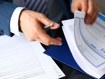Reviewing financial documents carefully.