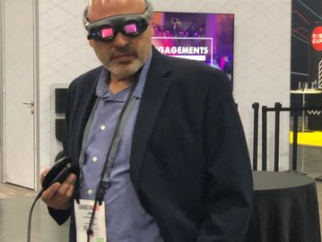 A show attendee dawning a Magic Leap 1 looking intently at AR content produced with makeSEA+Catapult