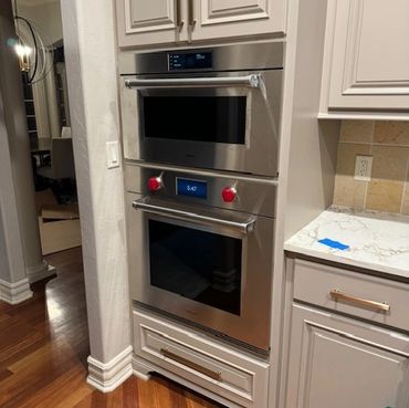 Modern double oven with digital controls in a stylish kitchen setup.