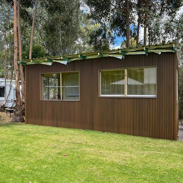 This shipping container covered with dark teak!