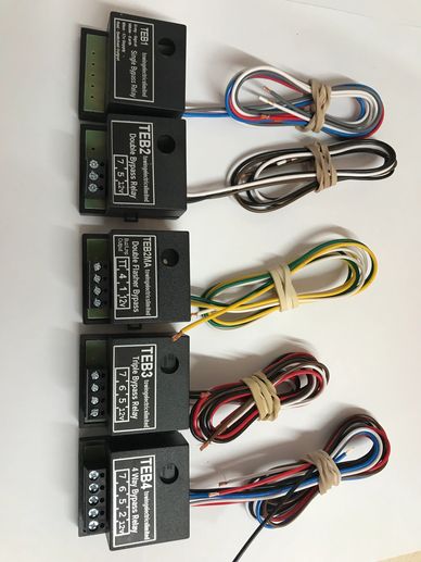 Several new smaller output bypass relays with wires neatly tied, on a clear white background.