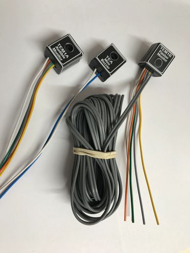 Three new audible monitors with wires tied together, on a clear white background.