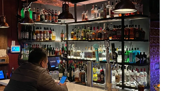 man sitting at the bar at Copper Bar Kitchen & Microbrewery in SF Castro District