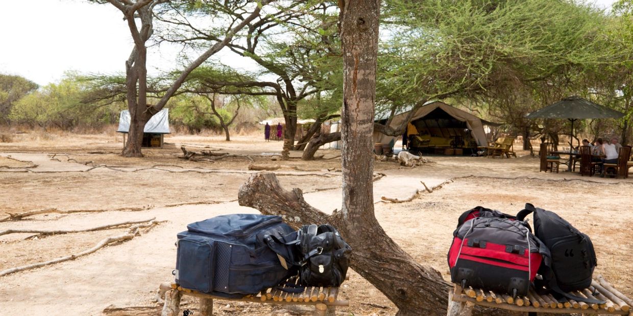 Safari packing gear and duffel bags at an African safari camp