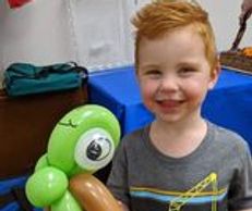 Balloon animals are included for all kids in our Big Bash package! Look how happy he is to have one!