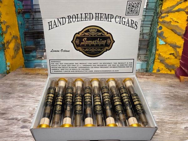Premium Something Famous hemp cigars in glass tubes with elegant branding display.