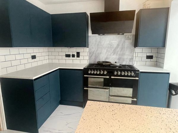Modern kitchen with dark cabinets and a black stove.