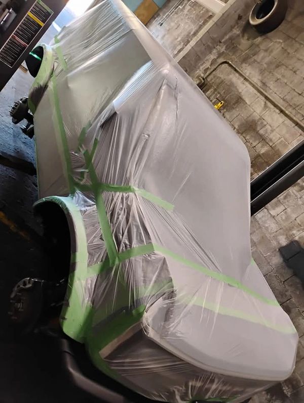 Vehicle wrapped in plastic before professional waxoyl application