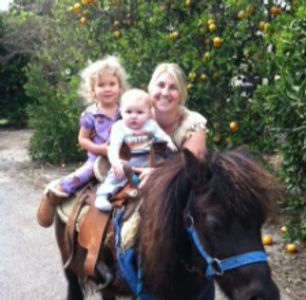 Tawni Angel and her kids riding a pony