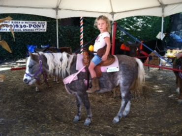 A girl riding a pony
