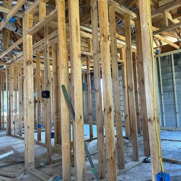 Wooden framing and electrical wiring in a building under construction.
