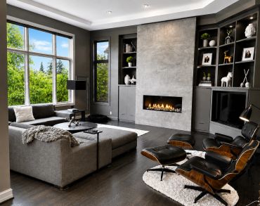 Modern living room with fireplace and large windows.