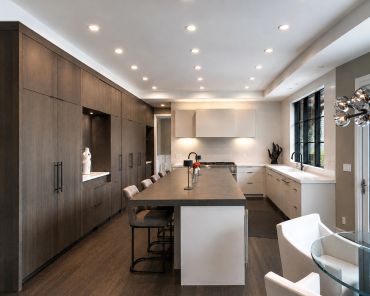 Modern kitchen with dark wood cabinets and island.