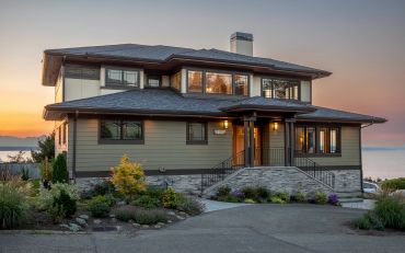 Modern two-story house with sunset lighting.