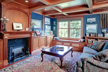 Cozy living room with wooden accents and a fireplace.
