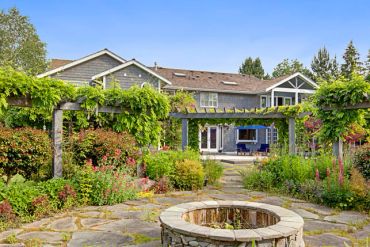 Beautiful backyard with stone fire pit and pergola.