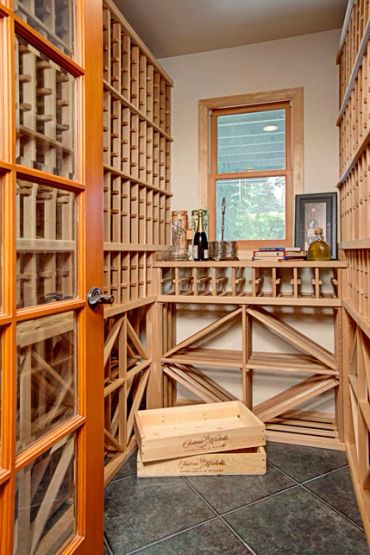 Wooden wine cellar with racks and crates.