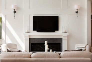 Cozy living room with TV above fireplace.