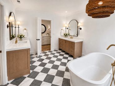 Elegant bathroom with checkered floor and dual vanities.