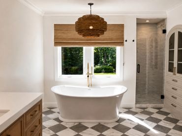 Elegant bathroom with freestanding tub and natural light.