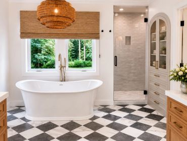 Modern bathroom with freestanding tub and checkered floor.