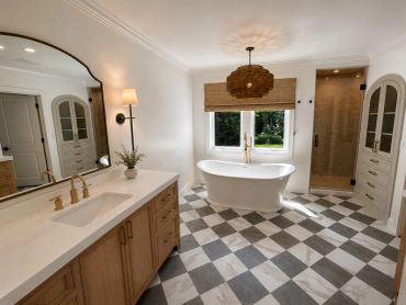 Modern bathroom with freestanding tub and checkered floor.