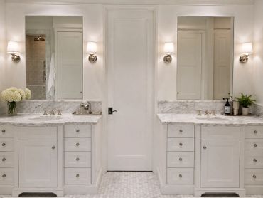 Elegant bathroom with dual sinks and marble countertops.