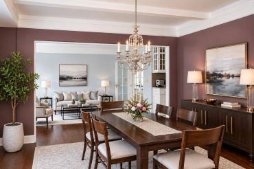 Elegant dining and living room with wooden furniture and muted colors.