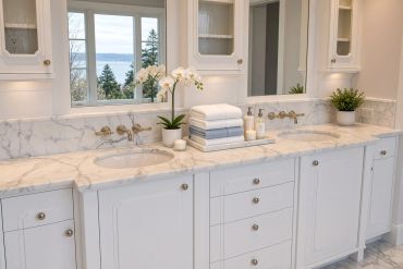 Elegant dual-sink bathroom vanity with marble countertop and white towels.